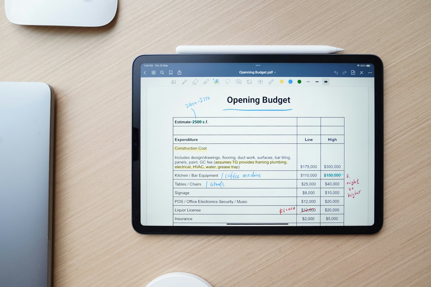 Tablet displaying financial budget on a wooden desk.
